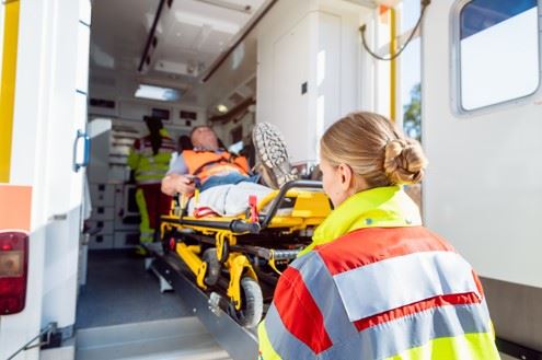 paramedics loading injury victim into ambulance